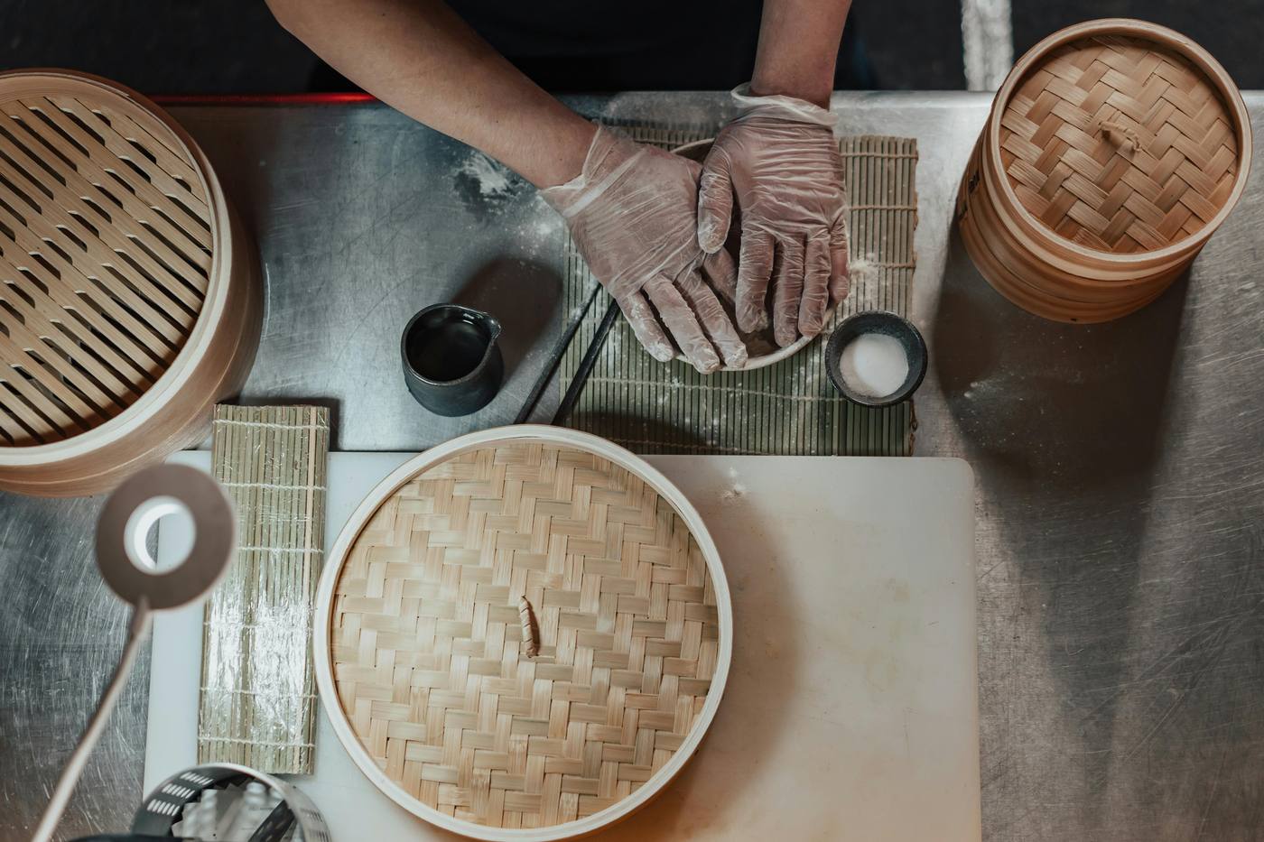 Chef preparing bamboo steamers in the kitchen